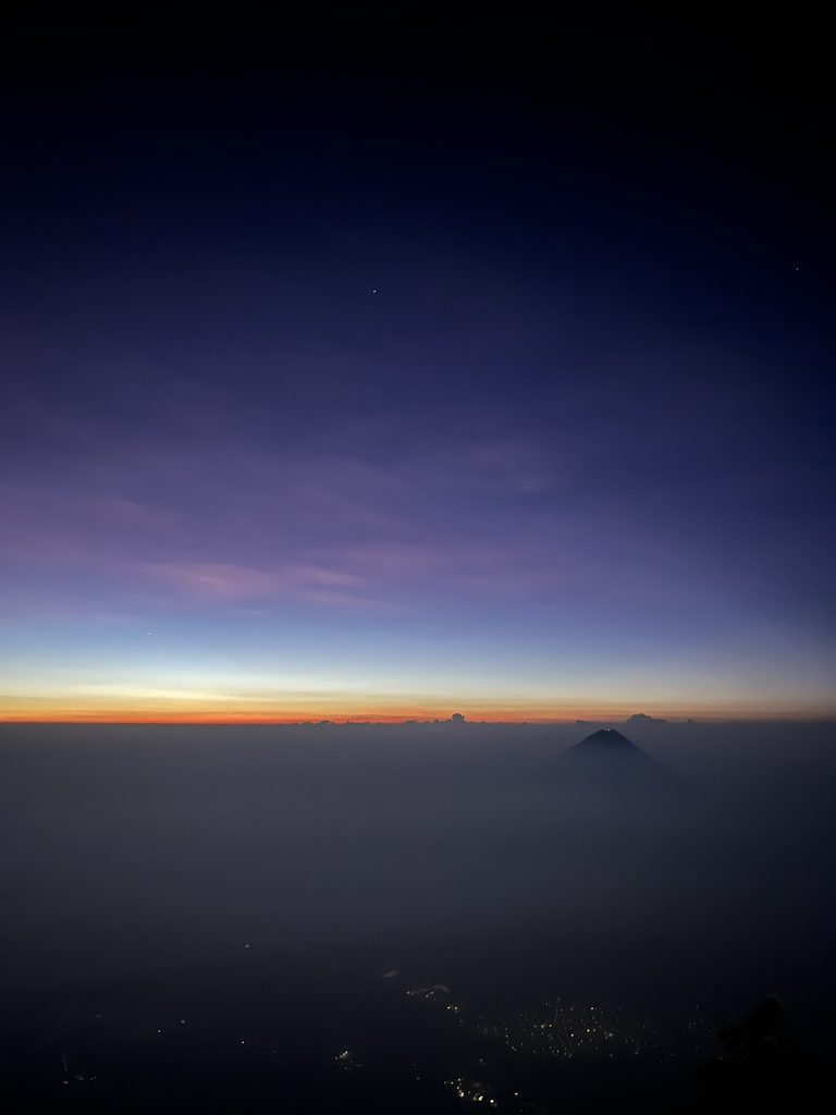 Colorful sunrise on Volcan Acatenango with Volcan de Agua in the distance